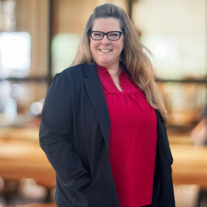 Tracy Walderon Account Executive red shirt black jacket